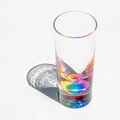 a shot glass sitting on top of a white table