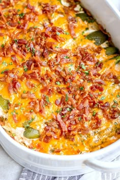 a casserole dish with bacon, cheese and green beans in it on a table