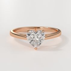 a heart shaped diamond engagement ring on a white background