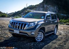 an suv is parked on the side of a mountain