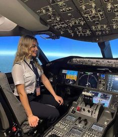 a woman sitting in the cockpit of an airplane