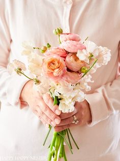 a person holding a bouquet of flowers in their hands