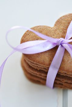 three heart shaped cookies tied with purple ribbon