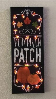 a sign that says pumpkin patch on it with lights in the shape of pumpkins