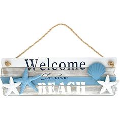 a sign that says welcome to the beach with starfishs and shells on it