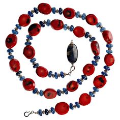 This unique necklace is an updated Southwest look with Red Coral and Blue Kyanite accented with detailed silvery spacers and a blue demortierite with Sterling Silver hooks clasp. The deep red bamboo coral is gently faceted and has interesting black accents. The blue Kyanite rondelles are highly polished and glowing. Our handmade necklace is a fashionable 28 inches. Artisan Hand-strung Red Coral Necklace, Unique Red Gemstone Bead Necklaces, Artisan Blue Necklace, Artisan Red Coral Necklaces For Jewelry Making, Unique Lapis Lazuli Gemstone Necklace, Artisan Red Necklaces For Jewelry Making, Unique Red Hand-strung Jewelry, Unique Hand-strung Red Jewelry, Artisan Hand-strung Red Jewelry