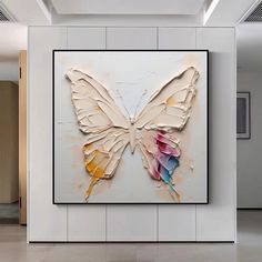 a large butterfly is on display in a white room with tile flooring and walls