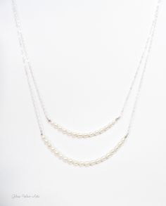 "Freshwater Pearl Strand Necklace ~ Available in 100% Sterling Silver, 14k Gold Fill or Rose Gold Fill Capture the beauty of nature with strands of genuine freshwater rice pearls - Perfect for the bride or bridesmaids gifts! - Genuine freshwater rice pearls in a beautiful white / ivory - Lengths are show at 17\" & 19\"- Measure and choose your favorite length - Chain is a sparkly sterling silver or 14k gold fill, or rose gold fill chain - Necklace closes with a 14k gold fill, rose gold fill Double Strand Pearl Chain Jewelry For Weddings, Double Strand Pearl Chain For Wedding, Double Strand Pearl Drop Jewelry For Wedding, Delicate Double Strand Necklace For Wedding, Delicate Double Strand Wedding Jewelry, Double Strand Pearl Drop Necklace For Weddings, Single Strand Sterling Silver Necklace For Wedding, White Double Strand Pearl Necklace For Wedding, Pearl White Double Strand Necklace For Wedding