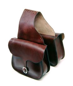 two brown leather bags sitting on top of each other