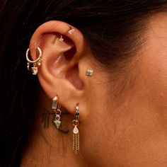 a close up of a person with ear piercings on their ears and behind the ear