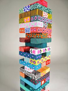 a stack of brightly colored ribbons on top of each other in different colors and patterns