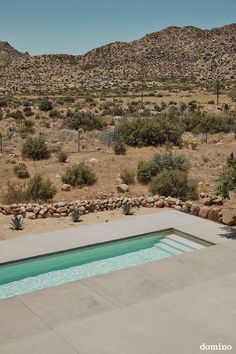 an empty pool in the middle of a desert