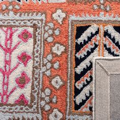 an area rug with different colors and designs on it