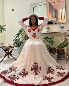 This shimena Ethiopian dress is an absolute showstopper, with its vibrant red color and intricate Tilf design. Made from high-quality fabric, this dress feels soft and comfortable against the skin, while the tailored fit flatters your curves and adds a touch of elegance to the traditional design. The Tilf embroidery on the neckline and sleeves is a true work of art, showcasing the skill and craftsmanship of Ethiopian artisans. The dress is made of menen fabric. The dress is perfect for special o Floor-length Dresses With Resham Embroidery For Traditional Ceremonies, Resham Embroidery Floor-length Dress For Traditional Ceremonies, Traditional Fitted V-neck Dress, Anarkali Style Long Sleeve Maxi Dress For Traditional Ceremonies, Traditional Red Dresses For Eid, White Dresses For Traditional Ceremonies And Festivals, Red Traditional Dress For Eid, Eid Anarkali V-neck Dress, Red Kaftan For Eid Traditional Ceremonies