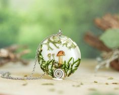 Step into the magic of the enchanted forest with this captivating real mushroom necklace, featuring dried lichen 🍃 and moss 🌿, all preserved in crystal-clear resin. This terrarium necklace captures the essence of wintery woodland beauty, making it the perfect accessory for those who love nature-inspired jewelry with a touch of magic. This winter necklace is not only a stunning piece of forest-inspired jewelry but also a thoughtful Christmas gift for nature lovers 🎄. Whether you're looking for a unique gift or a way to carry a piece of the forest with you, this necklace brings the tranquility of the woods to your style. 🌻 Our Mushroom Jewelry: https://www.etsy.com/shop/NatureResinJewelry?section_id=51201375 💚 Handmade with love and care 💚 ADDITIONAL INFORMATION 🎁 This unique nature n Forest Necklace, Winter Necklace, Mushroom Necklace, The Enchanted Forest, Mushroom Jewelry, Terrarium Necklace, Necklace Resin, Moss Terrarium, Thoughtful Christmas Gifts