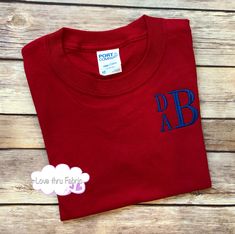 "These monogrammed t-shirts are made of a comfortable cotton fabric, making a casual, yet stylish, addition to the wardrobe of any boy. I offer boys t-shirts using four different styles of fonts. Shirts ordered from this listing will be monogrammed using a stacked font as shown in the listing picture. The order of the letters will be FIRST NAME as the top, small letter, MIDDLE NAME as the bottom small letter, and LAST NAME as the large letter. IMPORTANT: When placing your order please provide th Casual Cotton Monogram T-shirt, Customizable Cotton T-shirt For School Spirit, Red Cotton Tops With Name Print, Red Cotton Top With Name Print, Customizable School Spirit Red T-shirt, Customizable Red Crew Neck Shirt, Personalized Short Sleeve Cotton Shirt, Personalized Blue Cotton Tops, Personalized Cotton Short Sleeve Tops