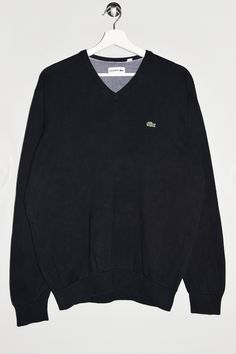 "Lacoste v-neck sweater in black. - Size tag: Please always check measurements before buying. Tag reads Men's XL, but fits like Men's L. - Measurements (laying flat): Pit to Pit: 21.5\" Length: 27\" Sleeve: 25\" Pit to Cuff: 19\" Across the shoulders: 17.5\" -Wear: /Please see images for details/ Good used condition. Slight color fading at places. - Fabric: Cotton *All of our items are preloved pieces so some signs of natural wear and age are to be expected. Please look through the photos carefully to check if the condition is to your satisfaction. *All efforts are made to show any defects however small imperfections may be missed. *We try to describe the sizes as accurately as possible, but please keep in mind that sizes nowadays can differ to sizes used back then. Please note the measure Black V-neck Cotton Sweater, Black Casual V-neck Sweater With Ribbed Cuffs, Black Cotton V-neck Sweater, Sporty Cotton V-neck Sweater, Kappa Tracksuit, Lacoste Jumper, Summer Sportswear, Sweater Streetwear, Retro Sportswear