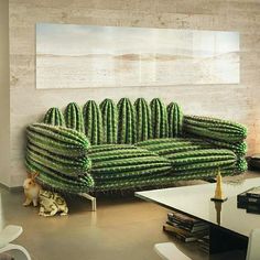 a living room filled with lots of green furniture