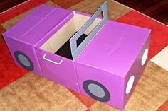 a purple cardboard car with its door open