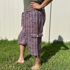 This pair of cargo shorts have green, white, and black colors.It was handmade by Ecuadorian artisans using the foot-treadle loom technique.It has a drawstring in the waist and the pant legs have tying drawstring hems. It has 2 pockets in the front and 2 pockets on the sides.Materials:75% cotton and 25% acrylic Measurements:Waist circumference: stretches from 30" to 40"Hip circumference: 48"Rise: 14"Inseam: 11"Total Length: 25"Thigh: 12"Leg opening: 11" Care instructions:Hand wash in cold water.D Beach Cotton Cargo Pants With Pockets, Cotton Cargo Pants With Pockets For Beach, Bohemian Short Length Bottoms With Drawstring, Casual Capris With Built-in Shorts, Casual Cotton Capri Cargo Pants, Casual Summer Cargo Capri Pants, Bohemian Bottoms With Drawstring Tie-side, Bohemian Tie-side Bottoms With Drawstring, Casual Capri Length Cargo Pants For Summer