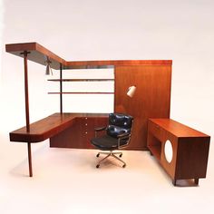 an office chair sitting in front of a desk with shelves and shelving on it