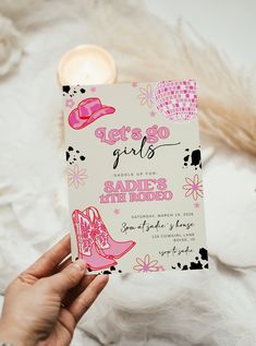 a person holding up a card with pink shoes on it