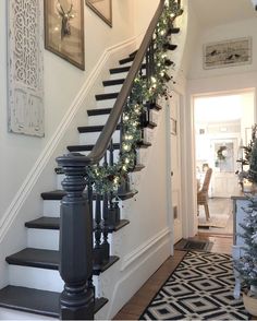 the stairs are decorated with christmas garland and lights