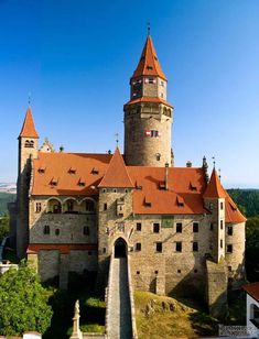 an aerial view of a castle with red roof tops and two towers on each side