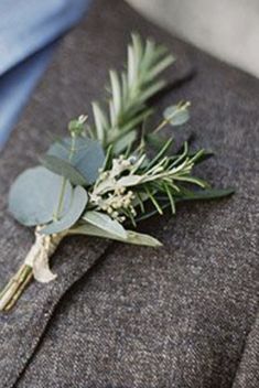 a boutonniere with greenery on the lapel