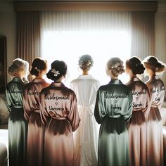 four bridesmaids in robes looking out the window