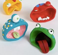 three plastic toys that look like mouths and teeth, one is green, the other is red