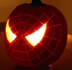 a spiderman pumpkin with its eyes glowing