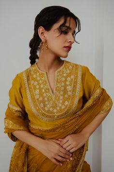 Mustard organza saree with aari hand embroidery. Comes with a blouse.
Components: 2
Pattern: Hand embroidered
Type Of Work: Aari
Neckline: Notched
Sleeve Type: Half
Fabric: Organza
Color: Yellow
Other Details: 
Note : Outfit worn by the model on the right is not for sale.
Occasion: Sangeet - Aza Fashions Embroidered Saree, Blouse For Women, Organza Saree, Saree With Blouse, Blouse Online, Wabi Sabi, Aza Fashion, Sleeve Type, Hand Embroidered