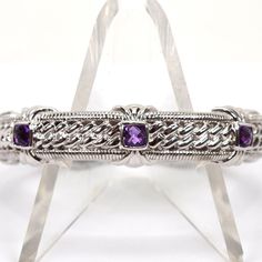 This Beautiful Judith Ripka Bracelet Features Three Square, Checkerboard Cut, Bezel Set Amethyst Stones. Floral Details 1.25" Opening 2.5" Diameter .5" Wide Medium Weight Hallmarked Professionally Cleaned Eb7536 Eaax Sterling Silver Amethyst Bracelet For Formal Occasions, Formal Sterling Silver Amethyst Bracelet, Elegant Sterling Silver Amethyst Bracelet, Elegant Purple Sterling Silver Bracelet, Elegant Sterling Silver Amethyst Bracelet For Formal Occasions, Elegant Purple Sterling Silver Bracelet For Formal Occasions, Elegant Formal Purple Sterling Silver Bracelet, Elegant Silver Cuff Bracelet With Gemstone Accents, Elegant Sterling Silver Bracelet With Gemstone Accents