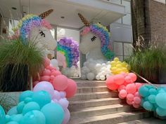 there are balloons in the shape of unicorns on the steps