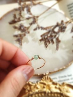 ✨ Dainty Light Green Jade Ring for Women ✨14K Gold Filled, Rose Gold Filled, Sterling Silver Wire Wrapped Tiny gemstone Ring💚 Simple stackable ring with a genuine green Jade, the good-luck stone. Jade is believed to bring protective, lucky-charm energy to the wearer 💚Sizing:• Gemstone Diameter: 4 mm• Ring Band: 0.8 mm • Handmade in your ring size with natural gemstone beads. • Dainty & cute. The ring is slim and petite, yet durable to wear daily. • Gold-filled is known for its lasting quality. Handmade May Birthstone Stackable Rings As Gift, Handmade Stackable May Birthstone Rings, Adjustable Gold Emerald Ring As Gift, Adjustable Gold Emerald Ring Gift, Handmade Adjustable Emerald Promise Ring, May Birthstone Stackable Jewelry, Stackable Round Jewelry For May Birthstone, Stackable Jewelry For May Birthstone, Stackable May Birthstone Jewelry