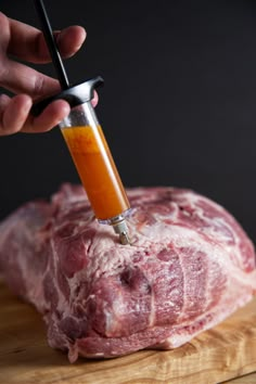 a person using a meat grinder to cut raw meat