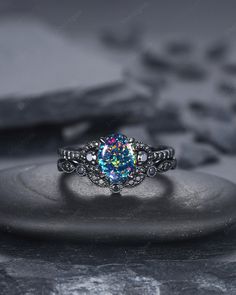 an engagement ring with a blue opal surrounded by multicolored stones