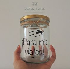 a person holding a jar with writing on it