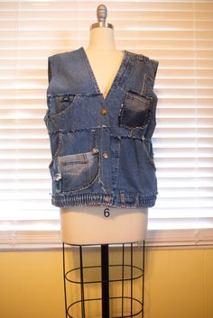 Utility Unisex Upcycled Denim Vest Inspired By Fishing Vest With Eight Pockets from Lee and other jeans scraps  It includes 3 Diagonal Pockets, 2 Patch Pockets, 3 Small Coin Pockets. Bust: 42" Waist: 42" Length: 23.5" Unique piece. Women's Size Large / Size X Large Men's Size Small/ Size Medium Welcome to my Youtube channel to see how I create stuff: @sophistitcated_stitch My channel: https://youtube.com/@sophisticated_stitch Mannequin size: Women's Size 6 The bottom button is from original Lee jeans, the other two buttons are added on from our design. Thank you for choosing Sophistitchation. Welcome to follow our Instagram: @sophistitchation Recycled Denim Vest With Pockets In Denim Blue, Medium Wash Patchwork Denim Vest, Medium Wash Patchwork Cotton Denim Vest, Blue Denim Vest With Pockets In Recycled Material, Blue Recycled Denim Vest With Pockets, Fishing Vest, Union City, Patchwork Denim, Upcycled Denim