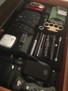 the contents of an electronic device are neatly organized in a wooden box on top of a table