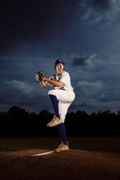 a baseball player is in the air with his glove up and ready to throw the ball