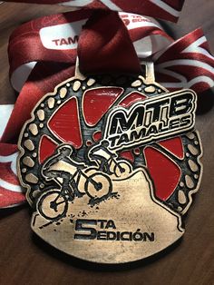 a medal with a ribbon around it that says mtb amajeta on the front