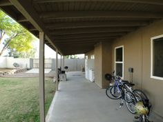 two bikes parked on the side of a building