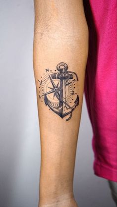 a person with a tattoo on their arm and an anchor in the middle of it