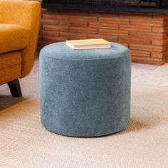 a blue ottoman sitting in front of a fire place