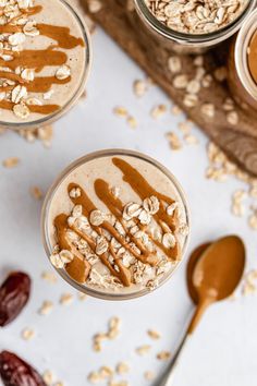 two glasses filled with peanut butter and oatmeal on top of a table