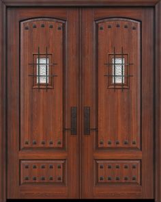 two wooden doors with metal bars on each side and glass windows above the top one