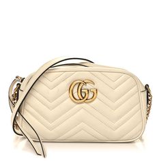 This is an authentic GUCCI Calfskin Matelasse Small GG Marmont Chain Shoulder Bag in White. This stylish shoulder bag is made of soft calfskin leather in off white. This shoulder bag features an antiqued gold chain and leather shoulder strap, and a Gucci GG logo on the front. The top zipper opens to a beige microfiber interior with a patch pocket. Gucci Luxury Soft Leather Shoulder Bag, Luxury Gucci Shoulder Bag In Soft Leather, Luxury Gucci Soft Leather Shoulder Bag, White Leather Gucci Shoulder Bag, Elegant Gucci Soft Leather Bags, White Gucci Shoulder Bag With Chain Strap, Gucci Cream Leather Shoulder Bag, White Gucci Shoulder Bag For Evening, Gucci Cream Crossbody Shoulder Bag