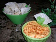 two green bowls filled with food sitting on top of a table next to each other